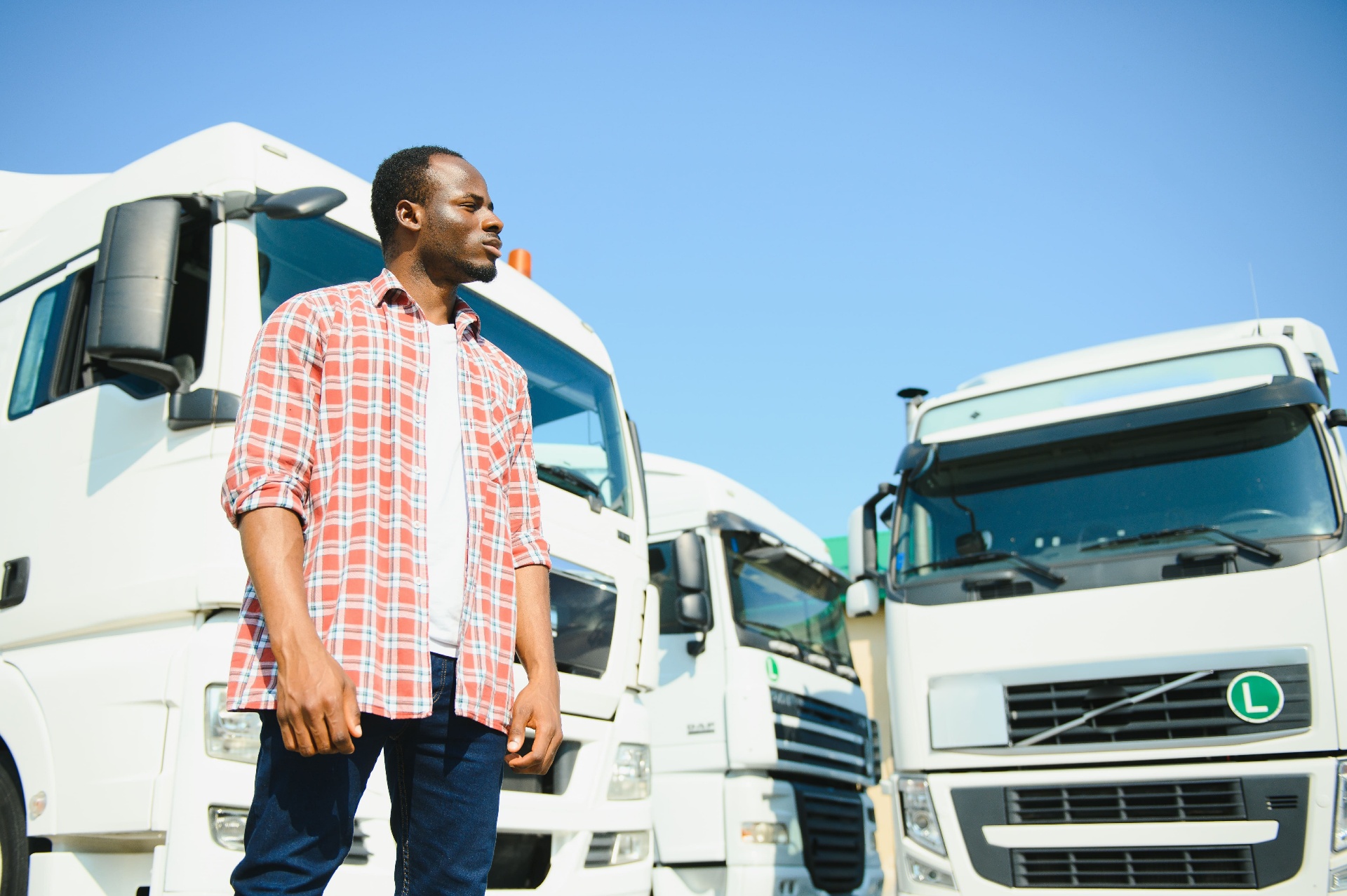 Driver in front of trucks at yard