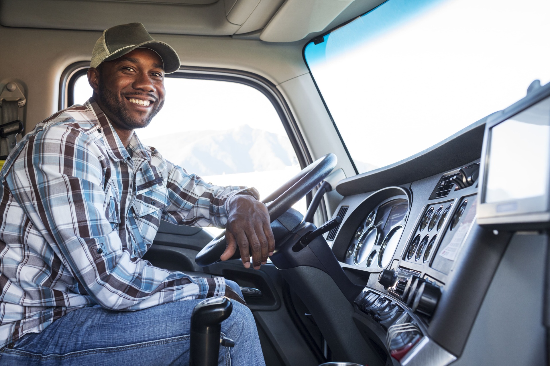 Truck driver smiling in cab